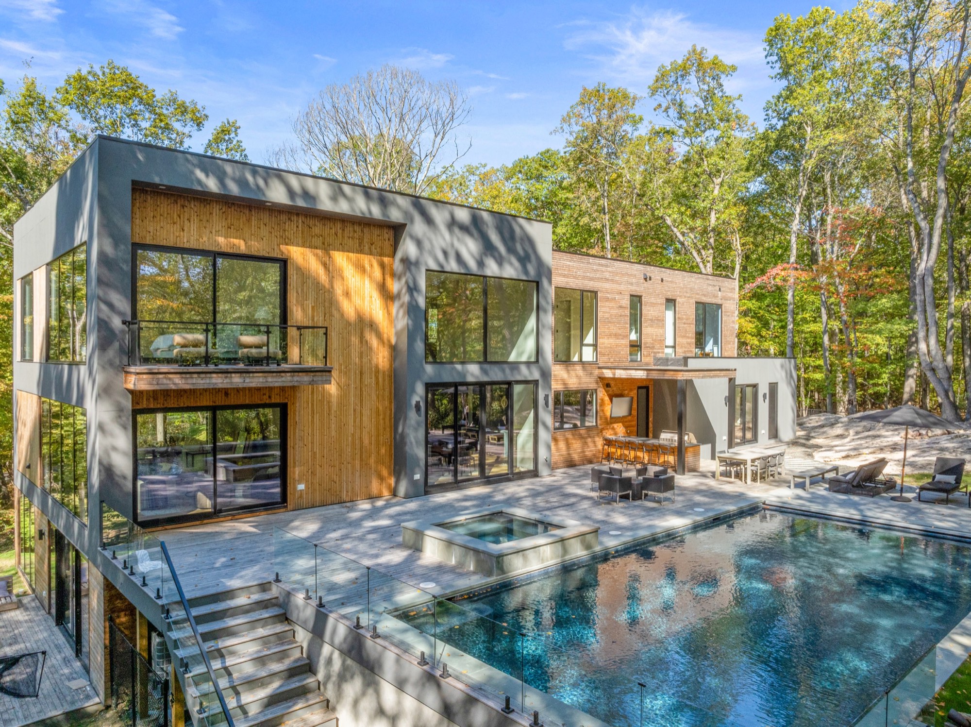 A completed CG Homes residence among tall trees in Greenwich, CT